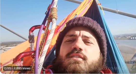 Marcus Carambola, 33, has been identified as one of the activists suspended above the QEII Bridge