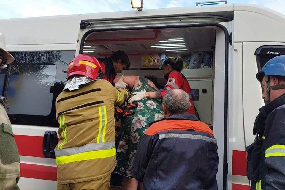 Rescue services carrying civilians out of a building that was hit during Monday's strikes