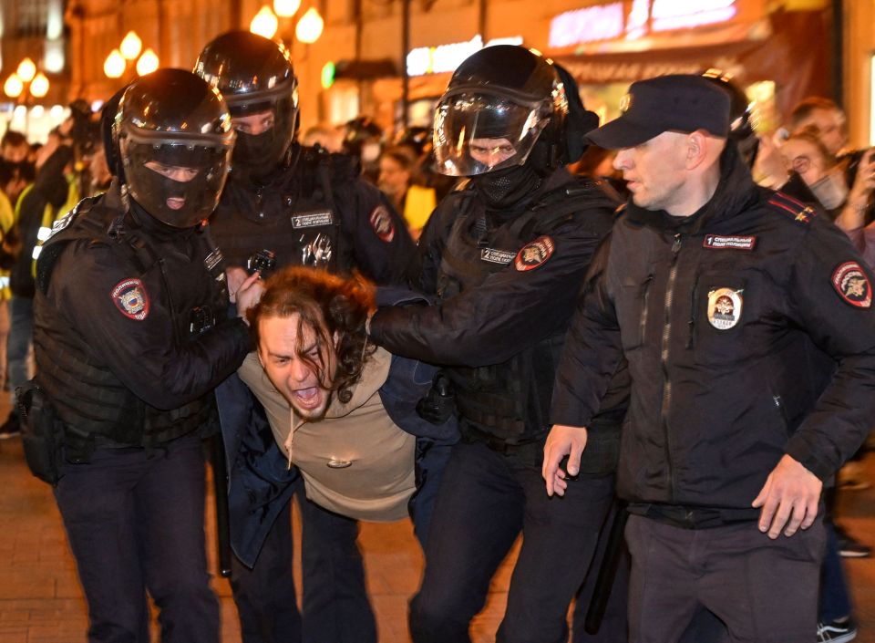 Police officers detain a man in Moscow amid protests against Putin's mobilisation plan