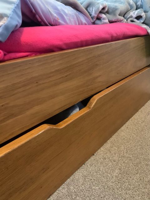 Her daughter also has a drawer under her bed in which to store books