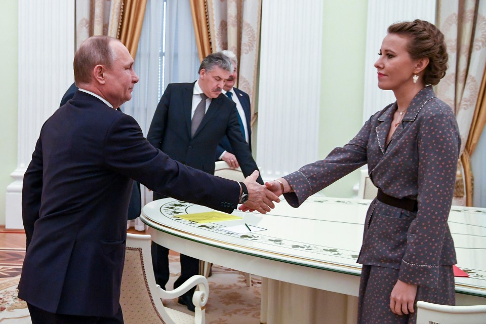 Vlad shakes Ksenia's hand in a ceremony for those running against the Russian leader in 2018