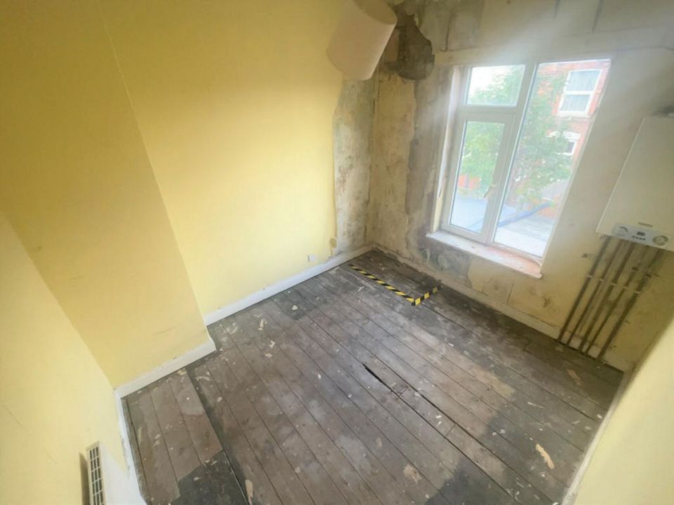 The rooms are stripped out, with bare floors and peeling wallpaper