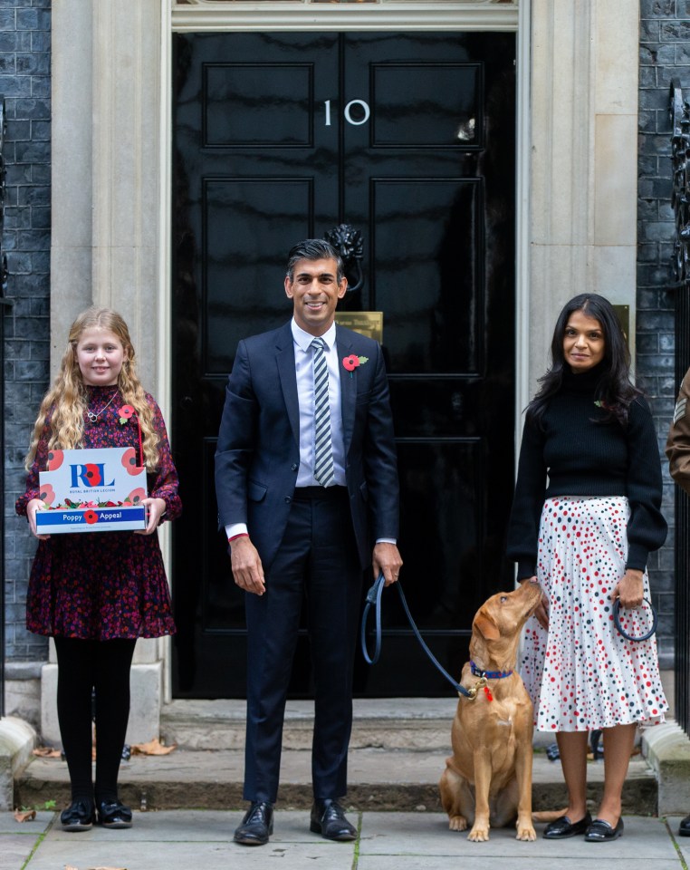 Prime Minister Rishi Sunak with his dog Nova are seen wearing poppies outside 10 Downing Street