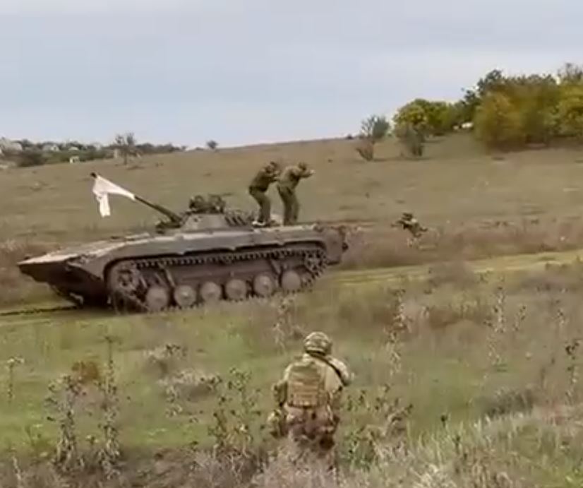 Russian soldiers emerging with their hands up