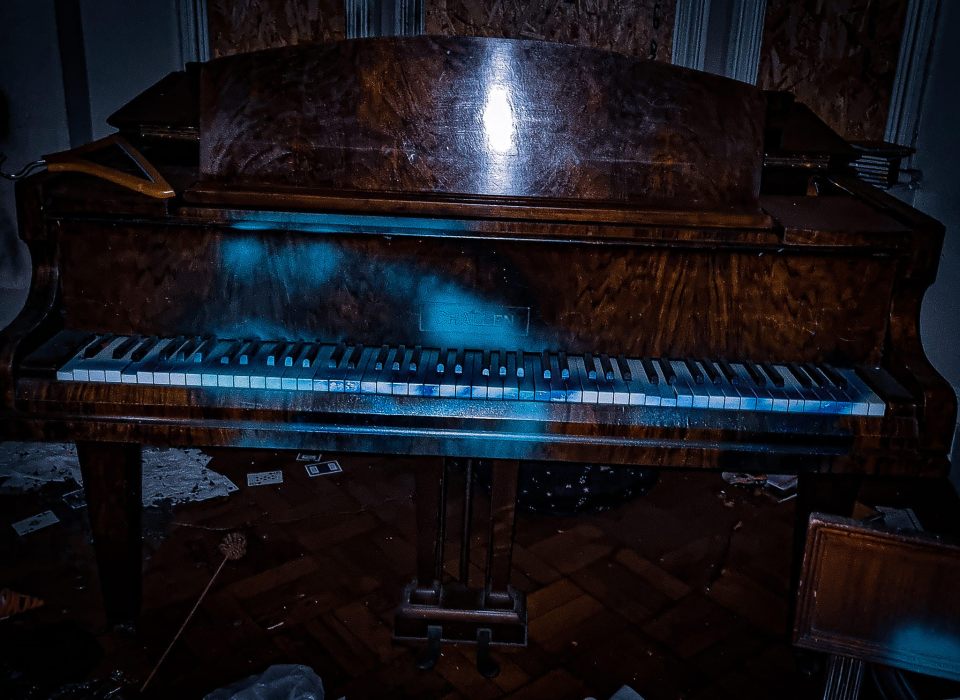 A piano is also intact, but spraypainted