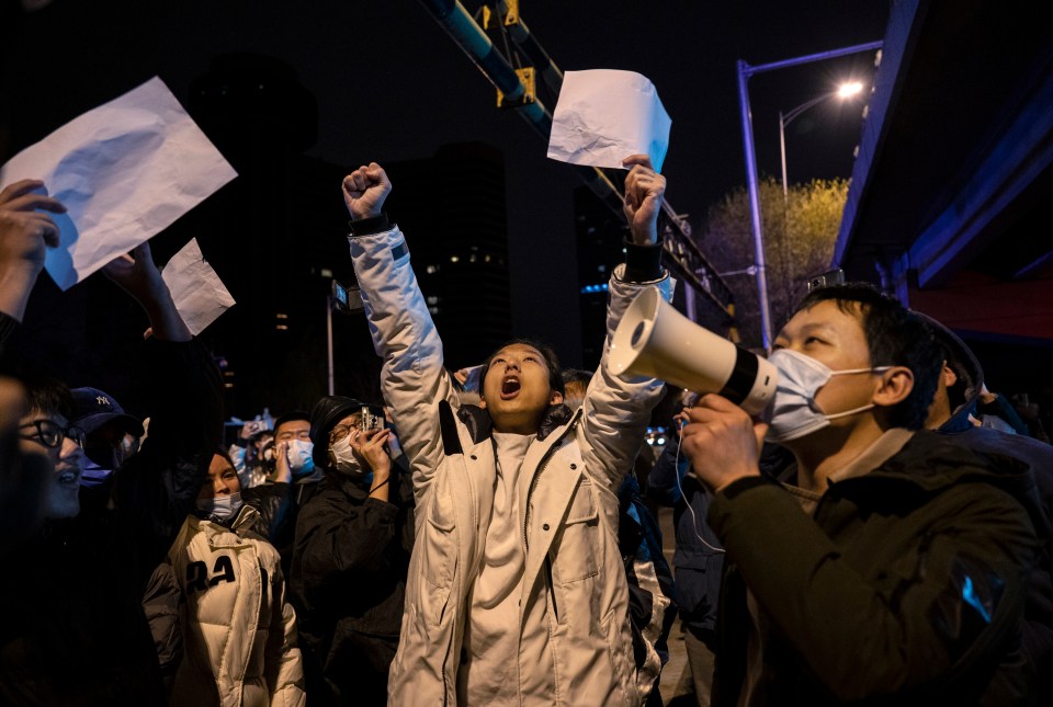 Protesters shout slogans during a protest against China's strict zero Covid measures