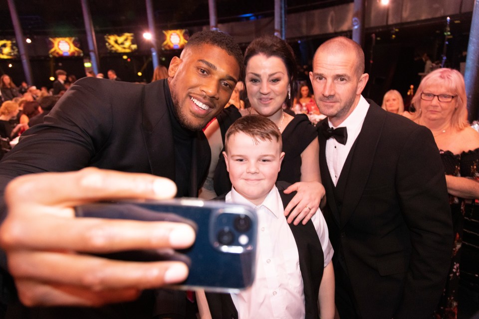 Anthony Joshua with Charlie Langford and his mum and dad. Charlie's late brother Rhys was nominated for the Unsung Hero award for raising thousands for a little boy's cancer treatment