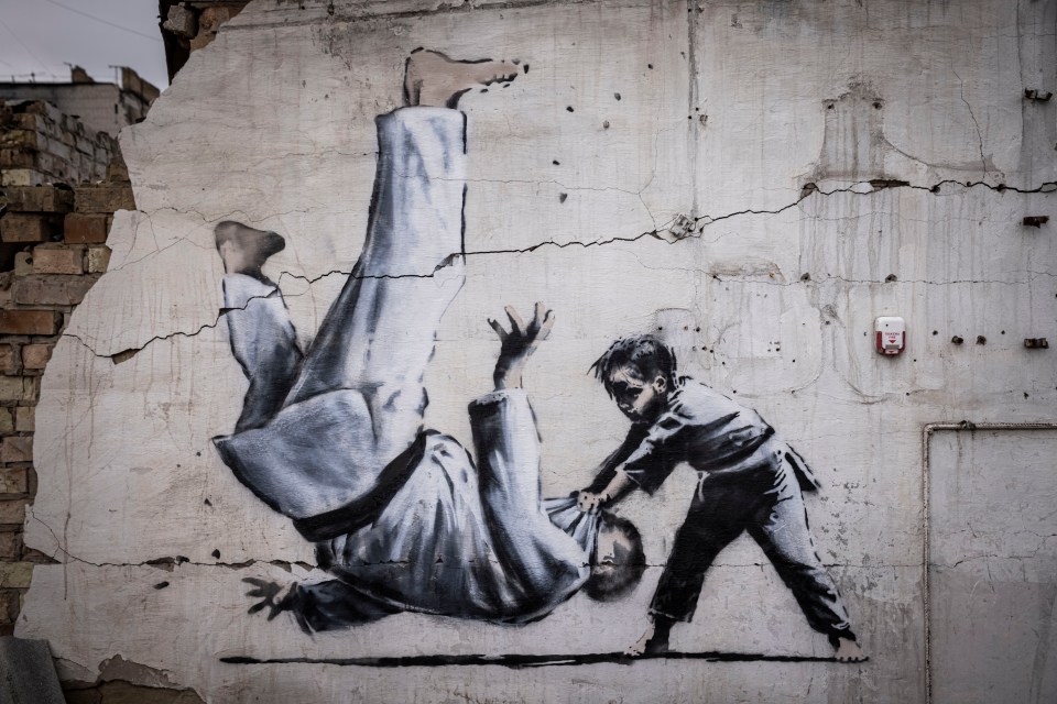 A painting of a child throwing a man on the floor on a wall in Borodyanka