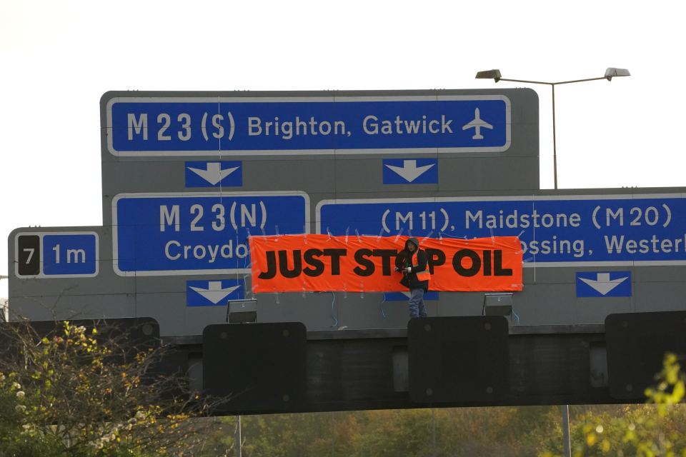 A protester pictured on a gantry today