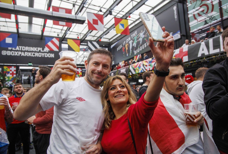 A woman takes a selfie as the excitement mounts