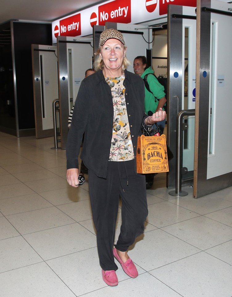 Sue was all smiles as she arrived back in the UK