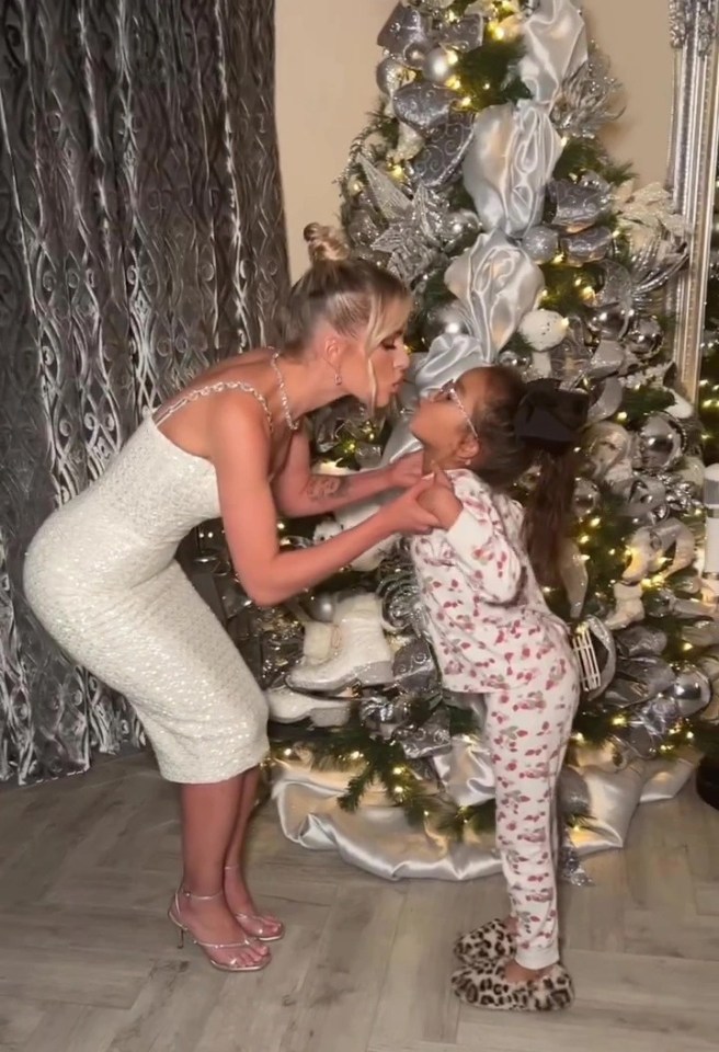 Helen Flannigan poses with her daughter in front of their own Christmas tree