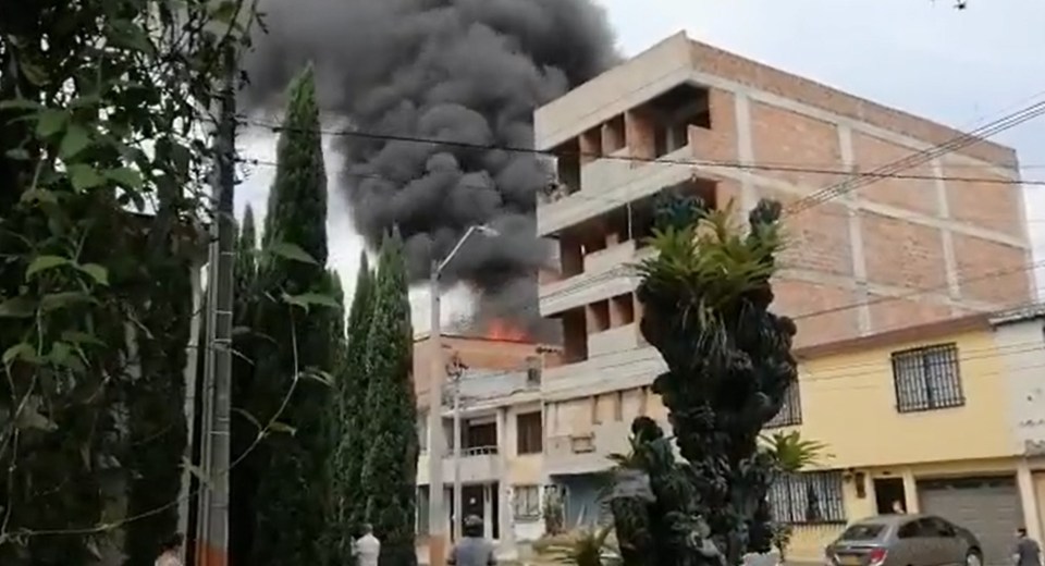 Thick black smoke was seen pouring from an apartment building in the city