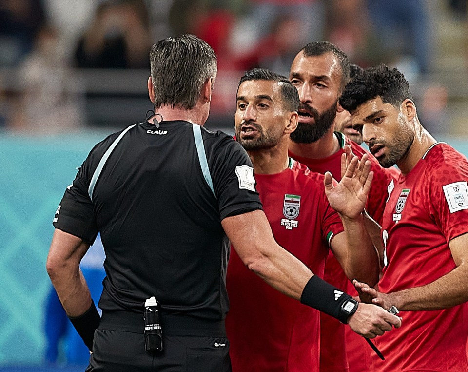 The officials have their names at the top on the back of their shirts