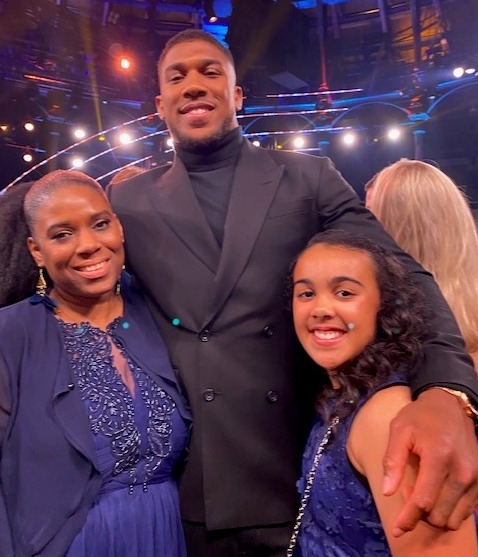 Young Hero nominee Jayden Sorhaindo, 11, and mum Natasha with boxer Anthony Joshua. Jayden calmly phoned for help and supported Natasha after she knocked herself unconscious while running a bath