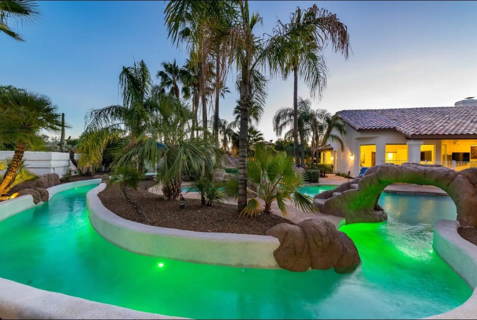 The pool area contains a salt-water resort pool, a lazy river, a rock waterfall, and a slide