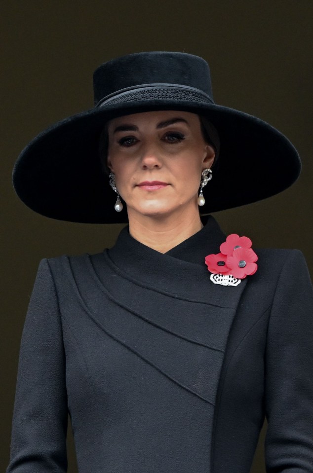 Sombre Kate wore all black and three poppies as she watched the service