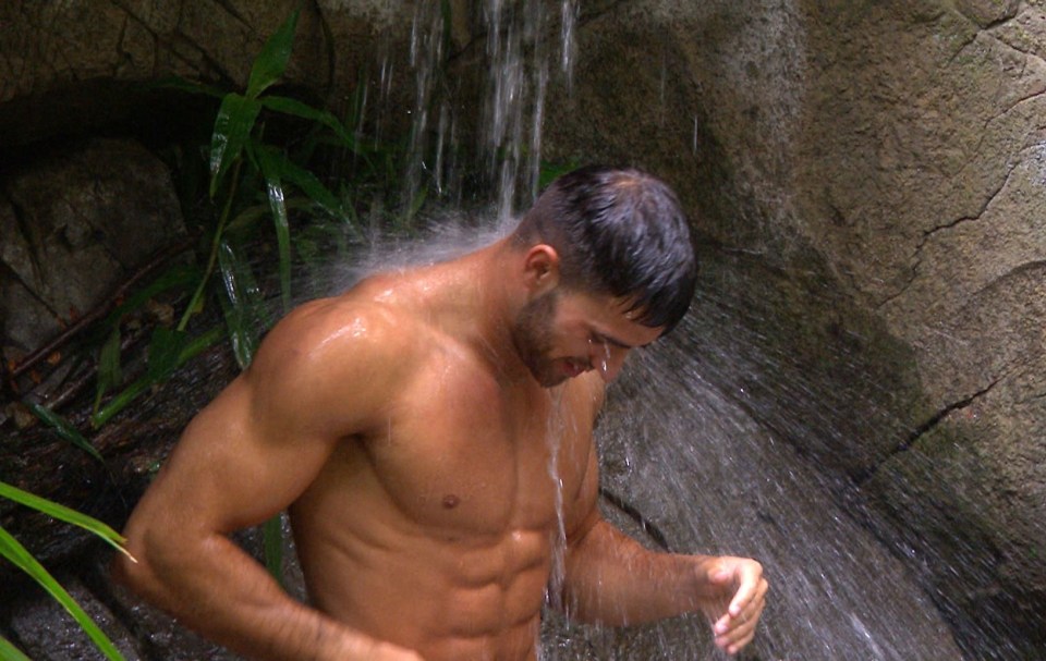 Owen shows off his six-pack in the camp shower