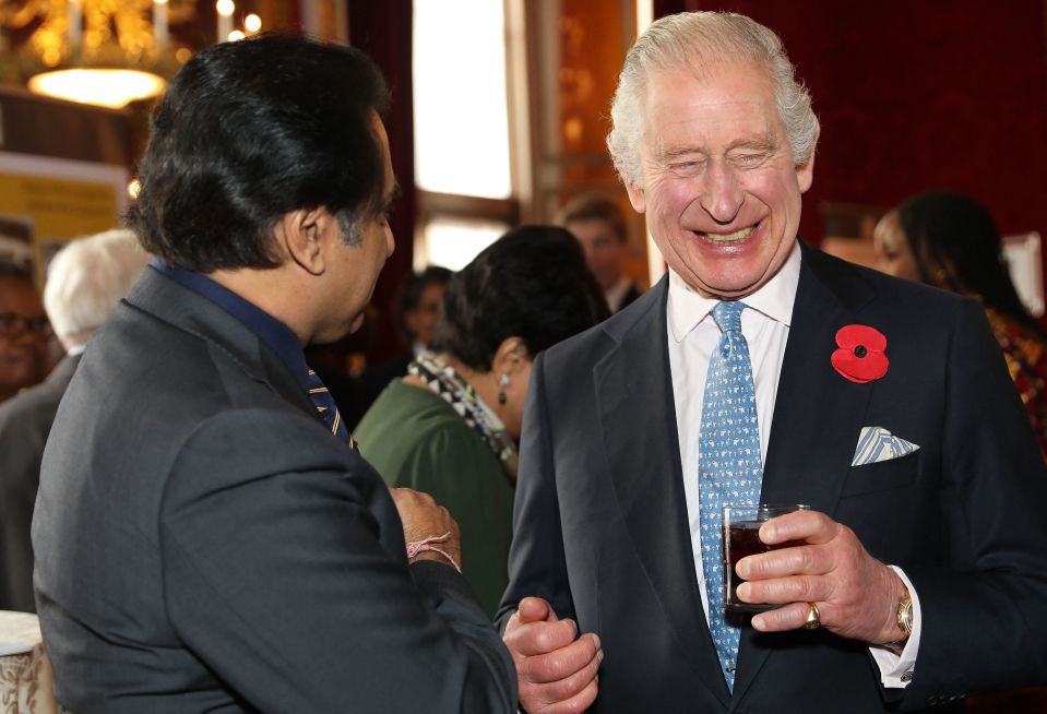 King Charles appears jolly as he hosts a reception in Buckingham Palace