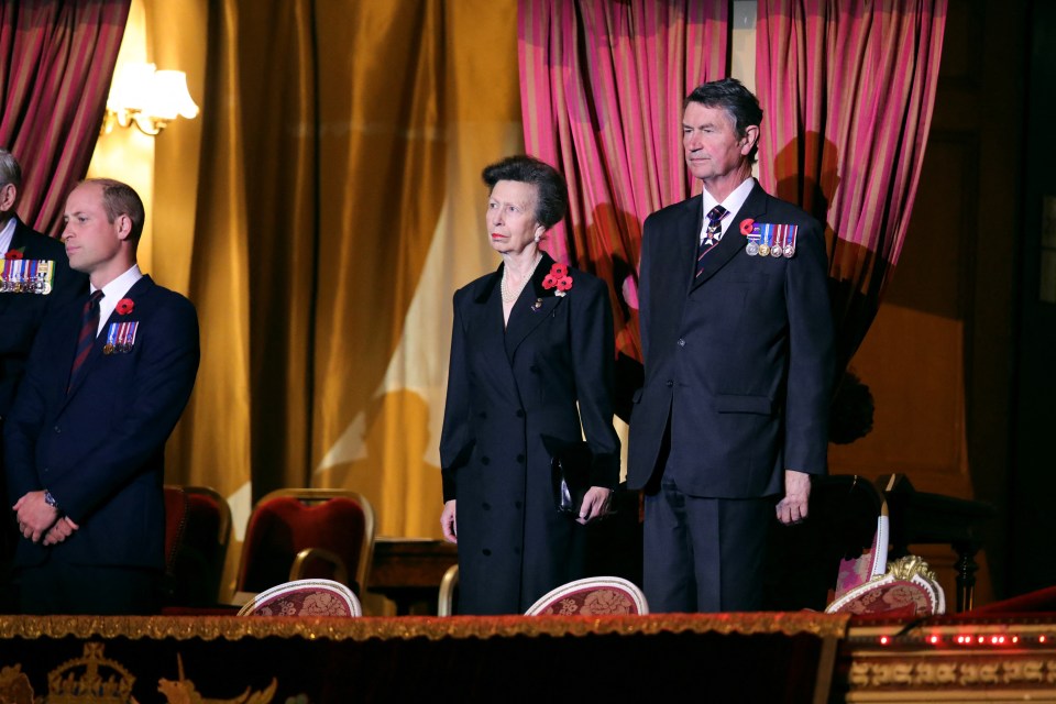 Princess Anne and husband Vice Admiral Sir Tim Laurence stand to pay their respects at the Royal Albert hall for the Festival of Remembrance