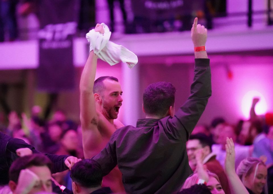 A jubilant fan waves his England shirt around as the team win their first game