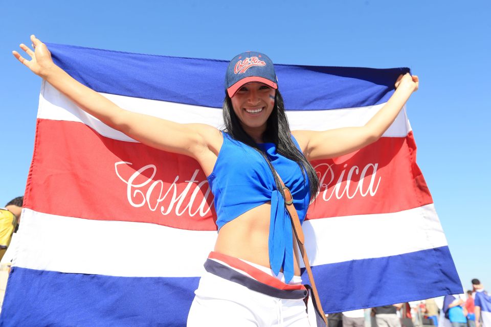 A Costa Rica fan poses for a photo outside a stadium at the 2014 World Cup