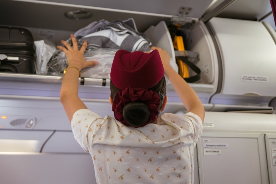 Crew are not allowed to help with suitcases in the overhead lockers