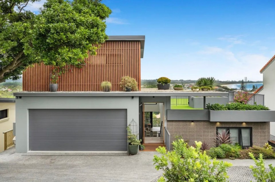 The house is set back from the road and features a modern interior