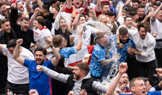 England fans celebrate as the Three Lions win 6-2 against Iran