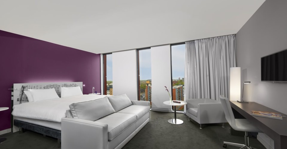 Rooms are clean, simple and modern, decorated in cool greys and creams with accents of purple