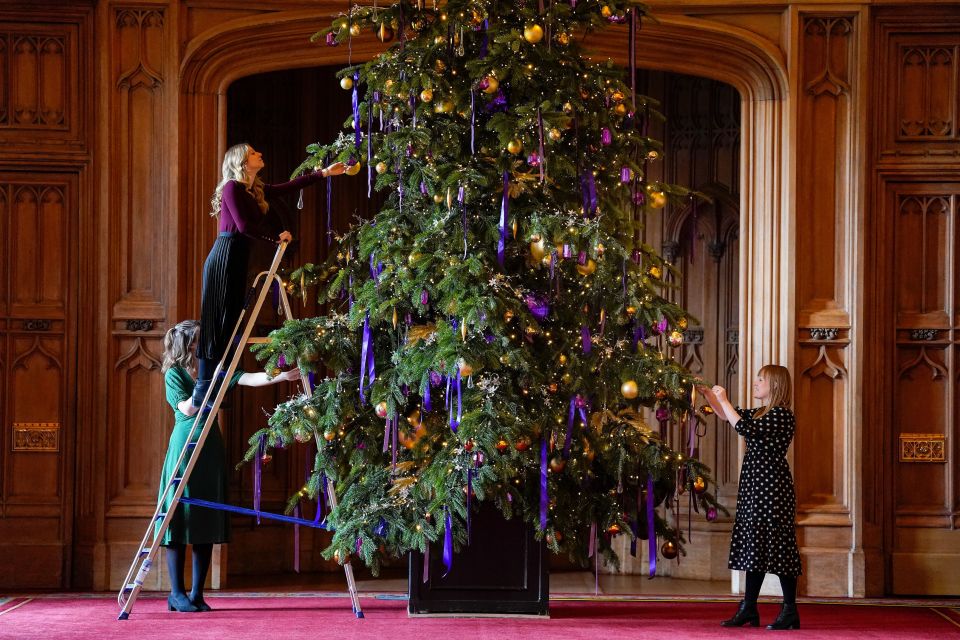 Purple decorations cover another huge fir - a nod to the late Queen