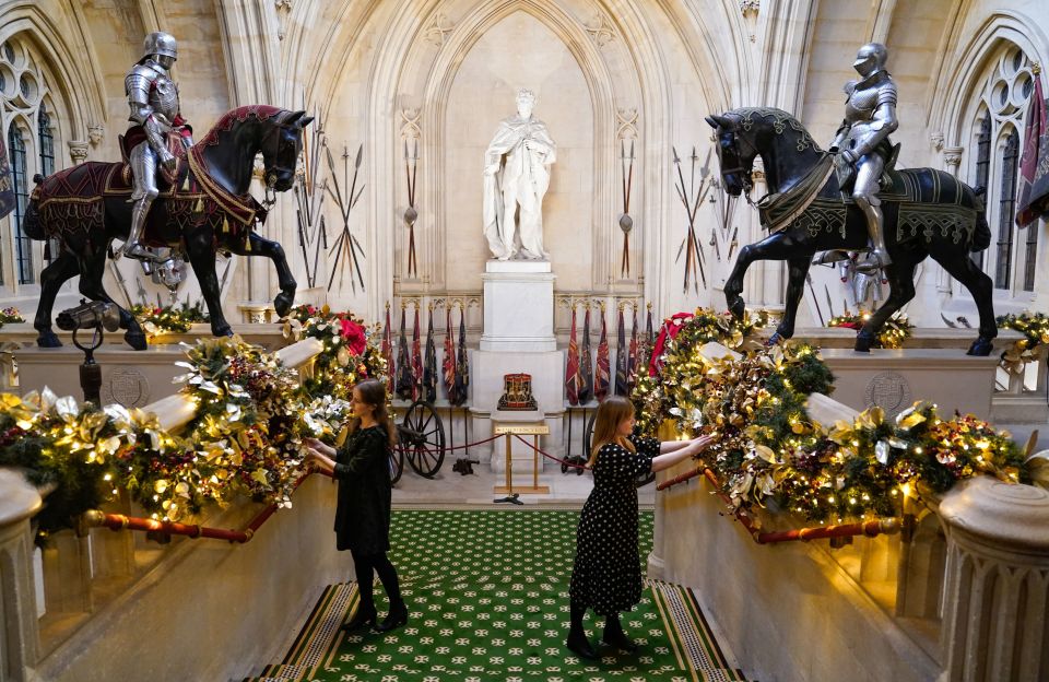 Members of the Royal Collection Trust put up decorations on the Grand Staircase last month