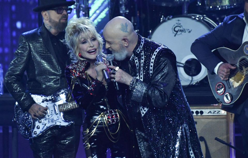 Musicians Rob Halford and Dolly Parton perform on stage