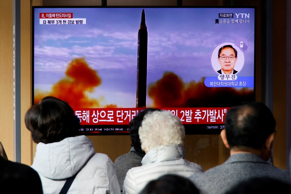 People in South Korea watch a TV broadcasting a news report on North Korea's missile launches on November 3