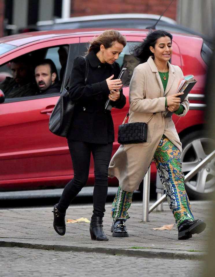 Griff watches as Maria and Alya head into a building