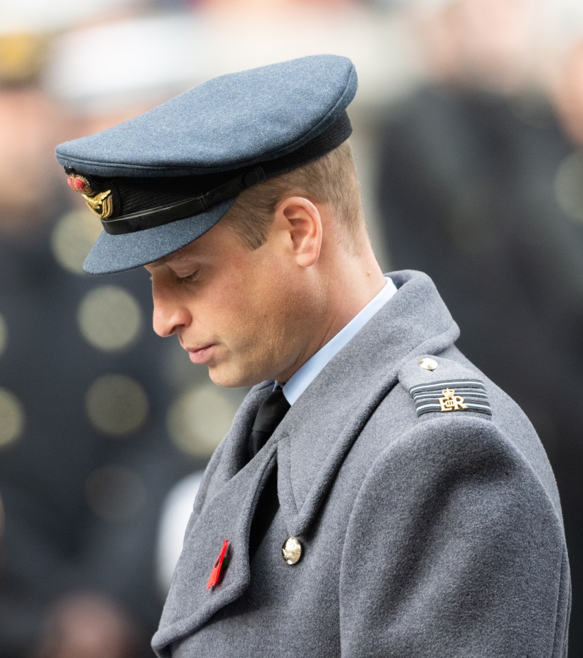 Prince William bows his head in silent thought