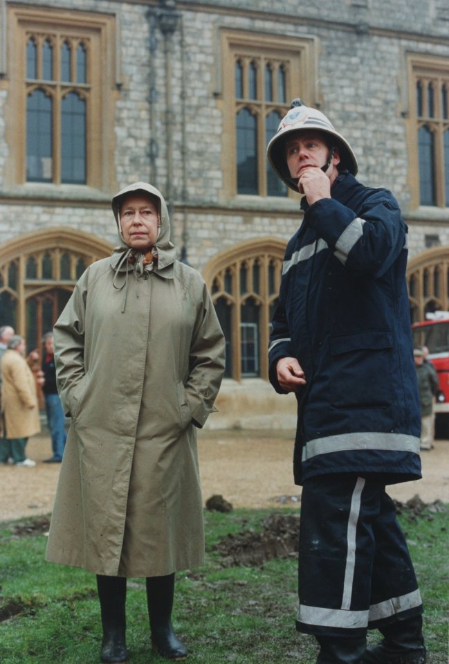 Queen Elizabeth II inspects the fire damage at Windsor Castle, the day after it when up in flames