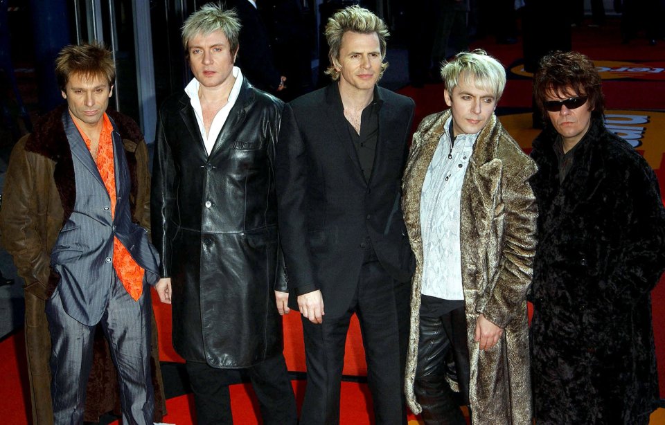 Andy Taylor, right, with Duran Duran bandmates Roger Taylor, Simon Le Bon, John Taylor, and Nick Rhodes at the Brit Awards in 2004