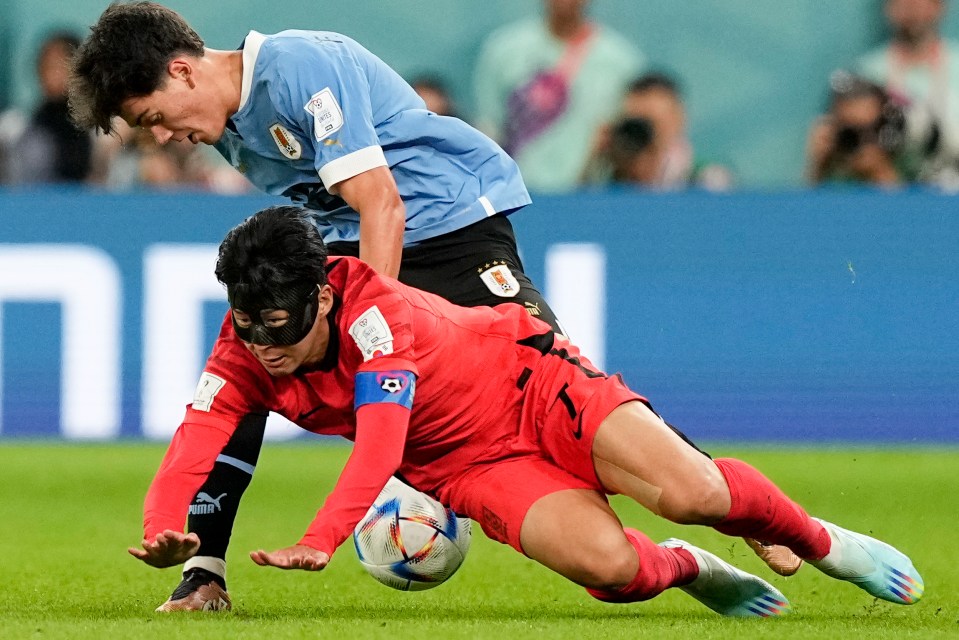 South Korea’s Son Heung-min is sent sprawling by Uruguay’s Facundo Pellistri