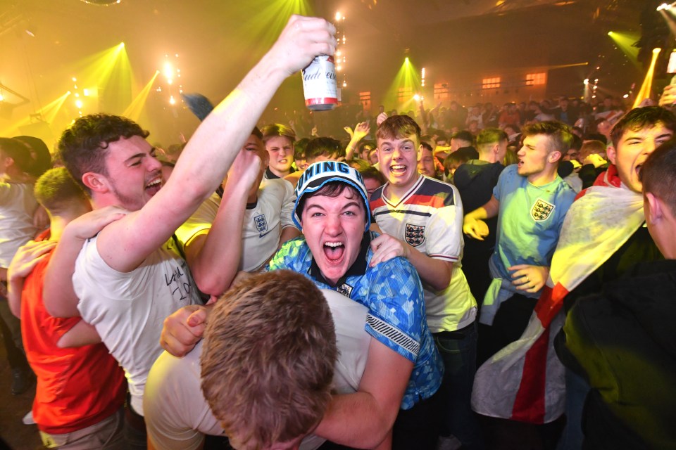 Supporters in Manchester leap on each other as England storm ahead