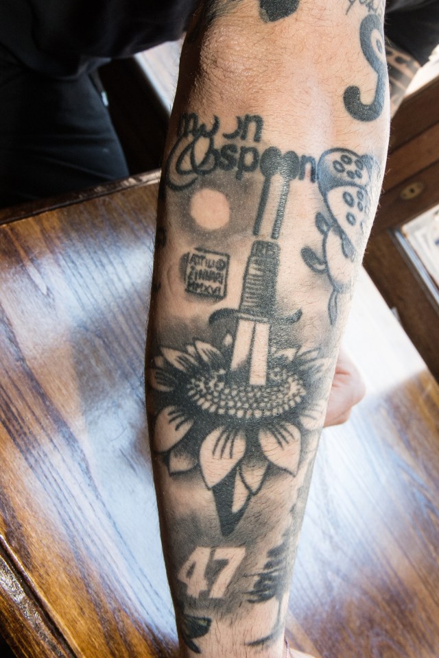 The Moon and Spoon pub logo is tattooed on Riccardo's lower arm