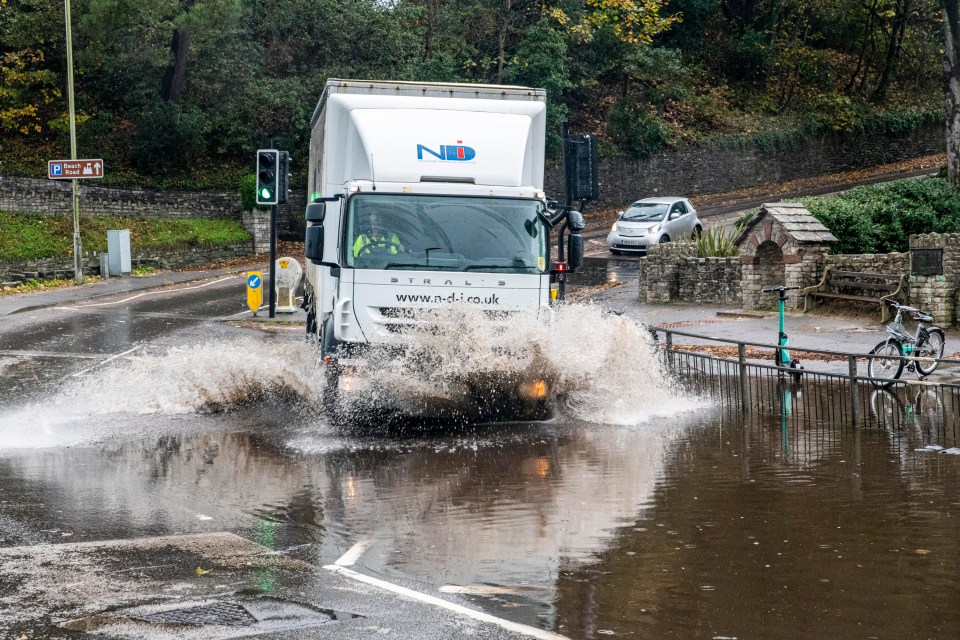 A truck ploughs through standing water in Dorset