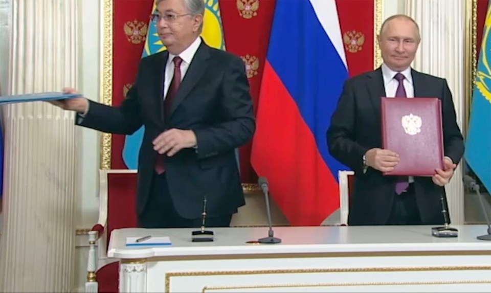 Putin and Tokayev exchanged documents with a brief handshake and eye contact – but only for a split second