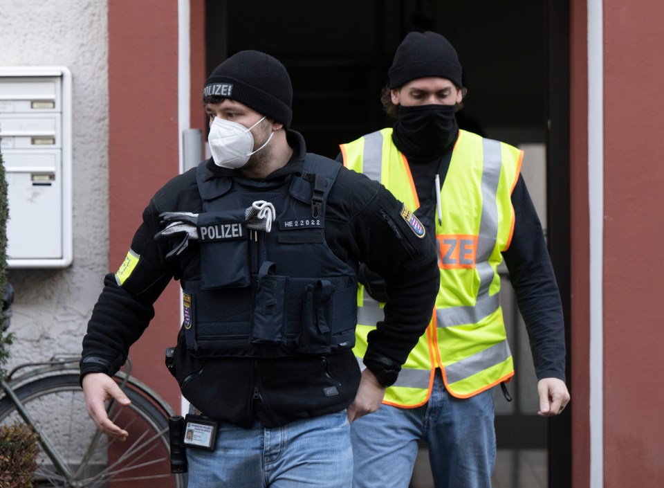 Police officers leaving a property in Frankfurt after raiding it