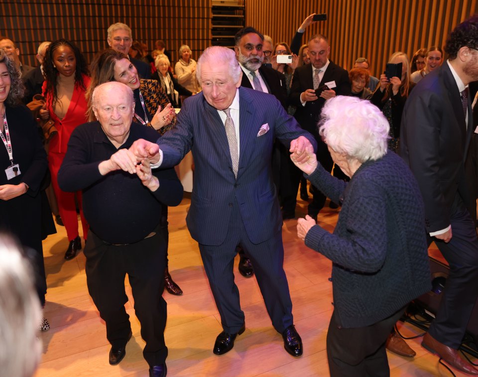 Charles dances with holocaust survivors during a visit to a Jewish community centre - pictured with Eva right