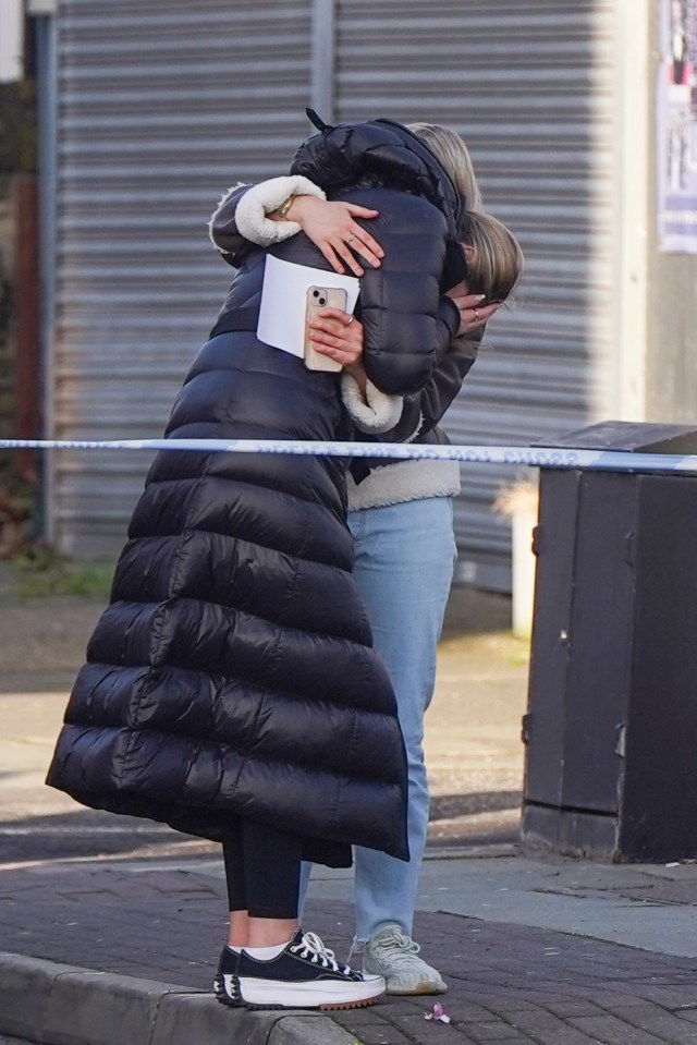 Heartbroken loved ones comforted each other as they laid floral tributes to Elle at the scene