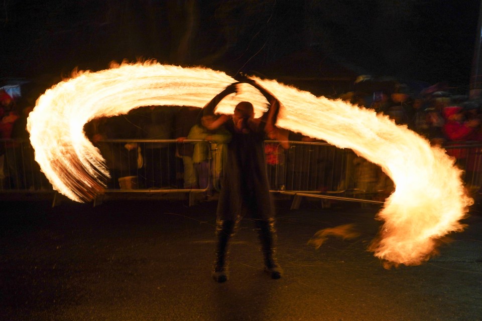 Viking re-enactors swing fireballs during New Year's Eve celebrations at the Flamborough Fire Festival in Yorkshire