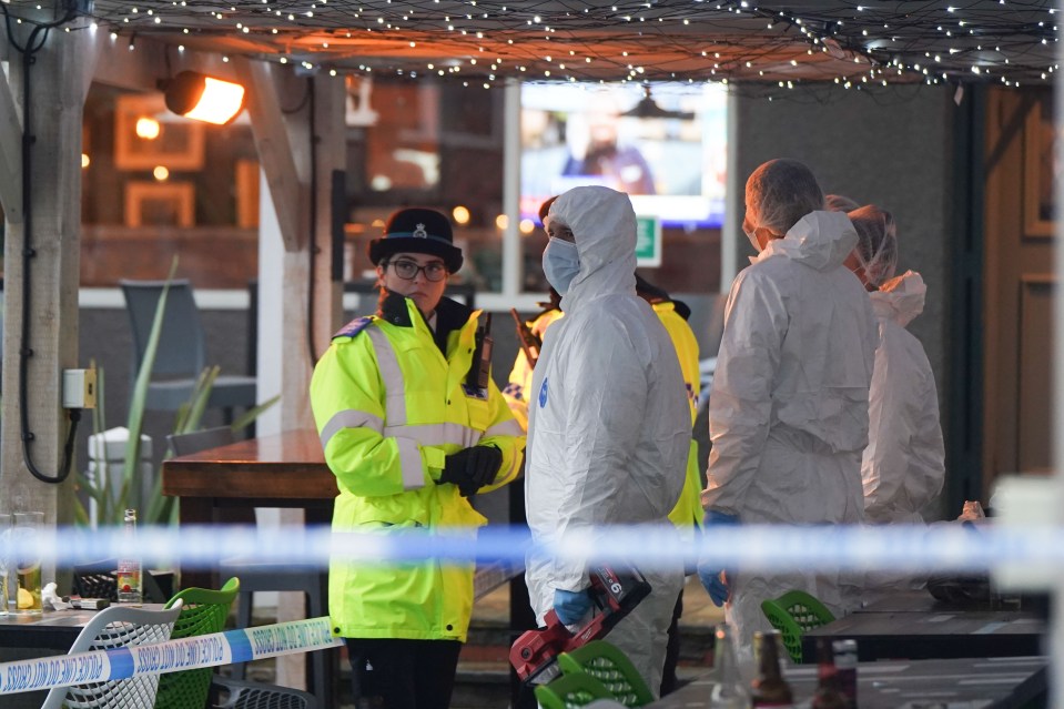 Cops and forensics officers combed the scene on Christmas Eve