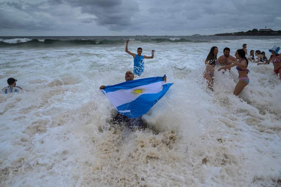 Fans of Argentina celebrate winning at the Copacabana beach in Rio de Janeiro, Brazil