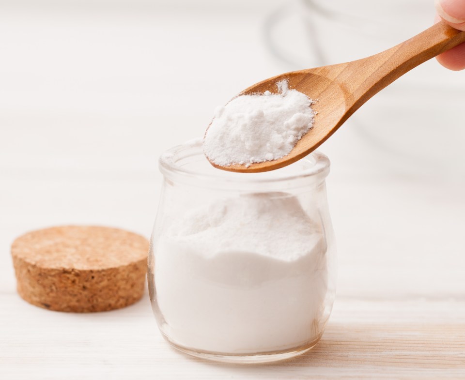 sea salt, starch in the jar and wooden spoon for recipes of cosmetics at home on a white wooden background